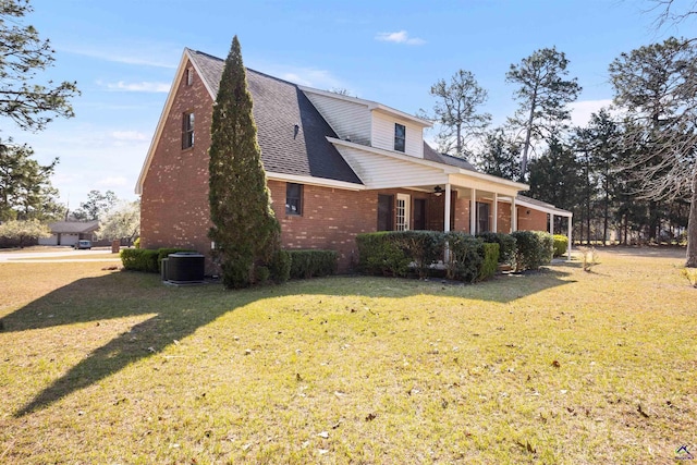 view of property exterior with brick siding, a porch, roof with shingles, cooling unit, and a yard