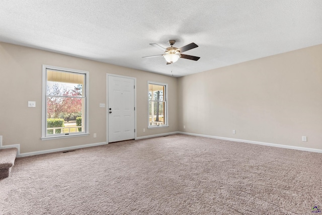 interior space featuring visible vents, a healthy amount of sunlight, stairs, and ceiling fan