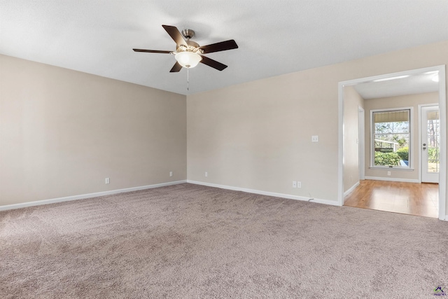 unfurnished room featuring a ceiling fan, baseboards, and carpet floors