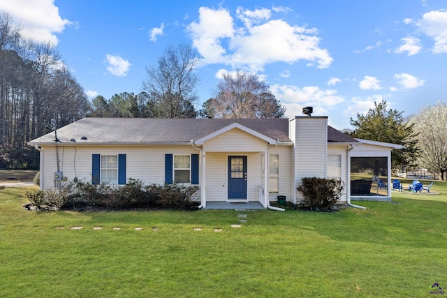 ranch-style house featuring a front yard, a chimney, and a shingled roof