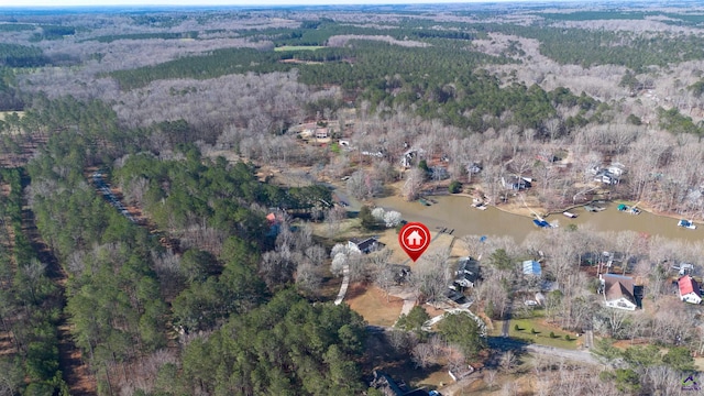 drone / aerial view featuring a forest view and a water view