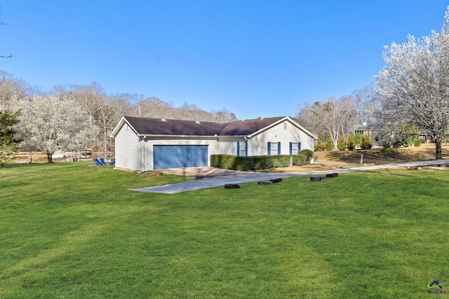 rear view of property featuring a yard and a garage