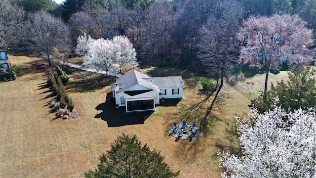 drone / aerial view featuring a wooded view