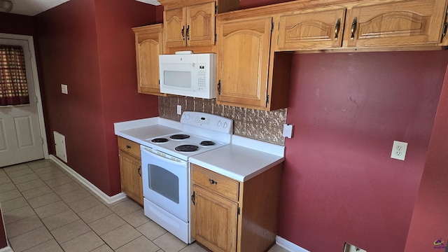 kitchen featuring white appliances, light tile patterned floors, light countertops, and tasteful backsplash