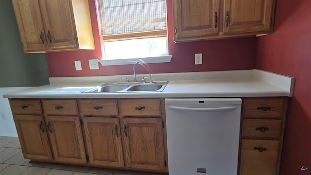 kitchen with brown cabinets, dishwasher, light countertops, and a sink