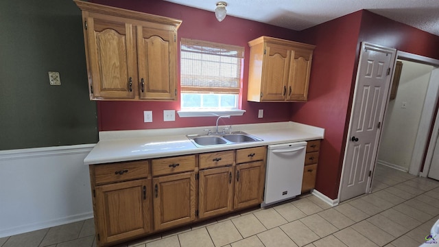 kitchen featuring a sink, brown cabinets, light countertops, and white dishwasher