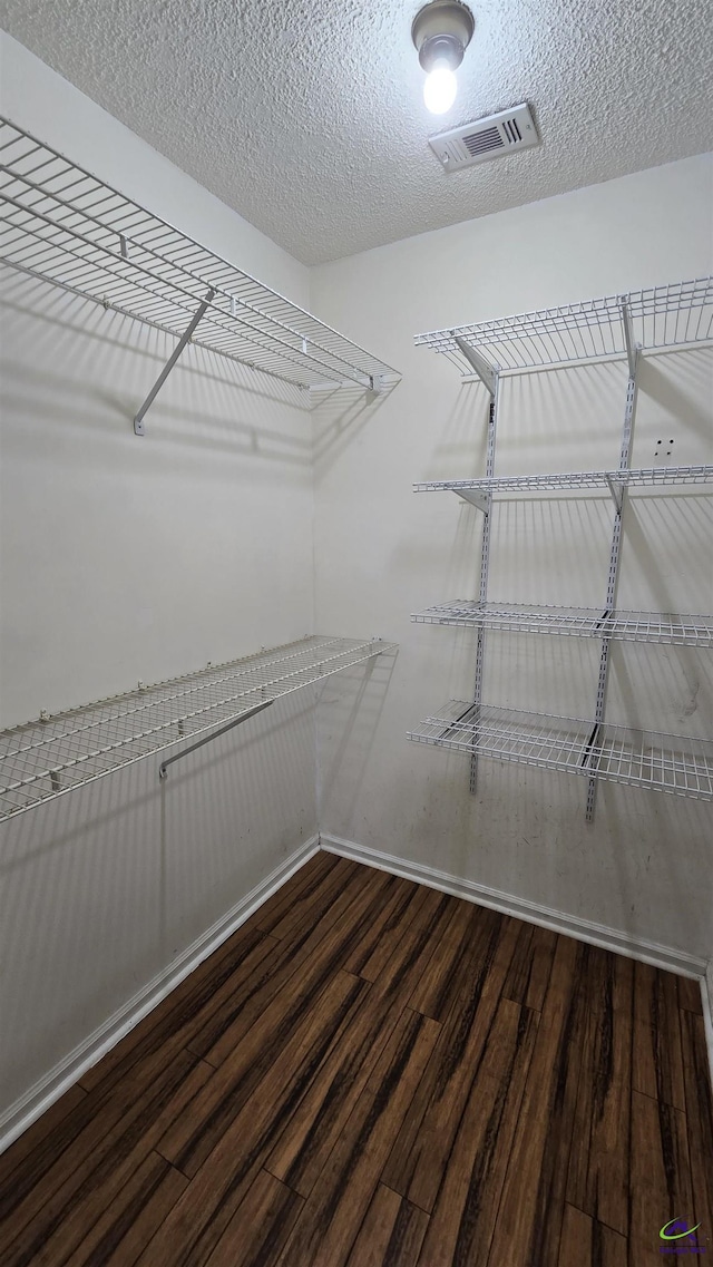 spacious closet with visible vents and wood finished floors