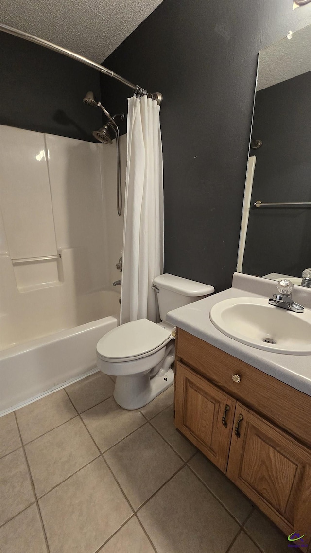 full bathroom with tile patterned floors, toilet, a textured ceiling, shower / bath combination with curtain, and vanity