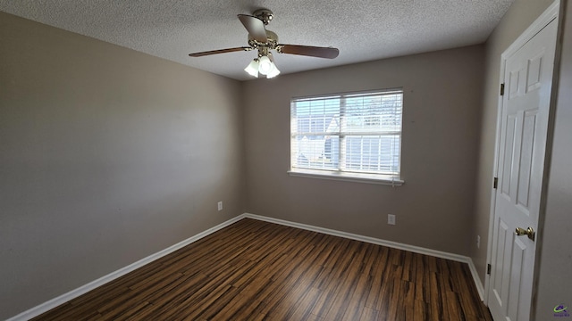 empty room featuring dark wood finished floors, ceiling fan, baseboards, and a textured ceiling