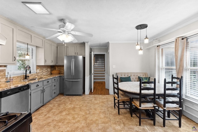 kitchen with freestanding refrigerator, gray cabinetry, a sink, black range oven, and dishwasher