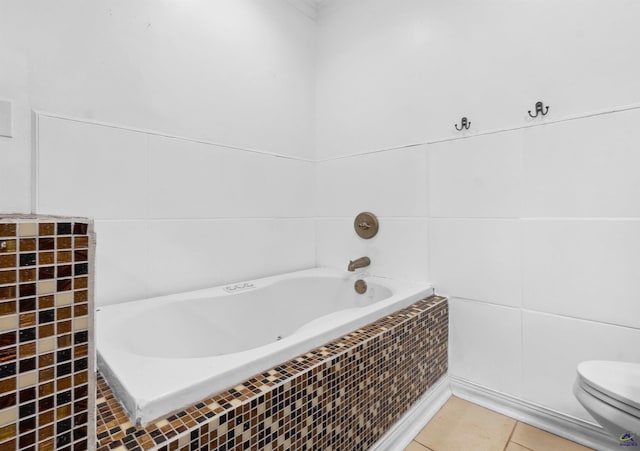 full bath featuring tile patterned flooring, toilet, a bath, and tile walls