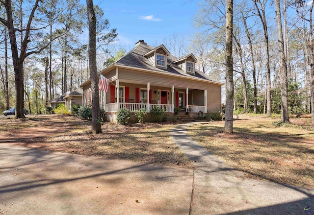 view of front of home featuring a porch and a chimney