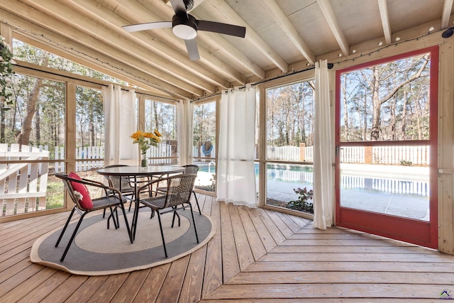 sunroom / solarium featuring lofted ceiling and ceiling fan