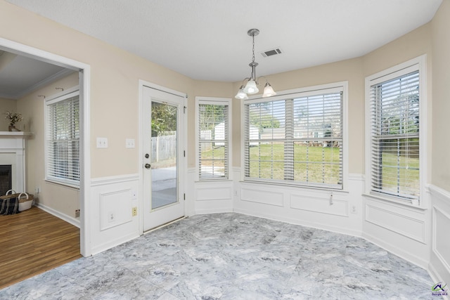 unfurnished sunroom featuring visible vents, a chandelier, and a fireplace