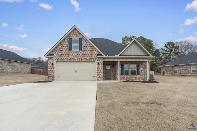 craftsman-style home with brick siding, concrete driveway, a front lawn, and roof with shingles