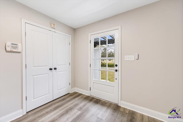 entryway with wood finished floors and baseboards