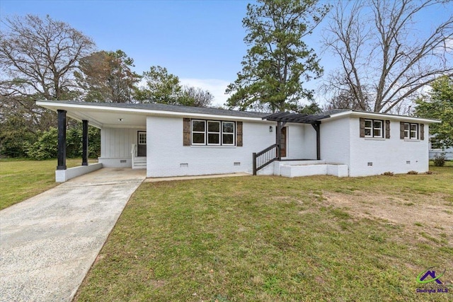 ranch-style house with brick siding, a carport, a front yard, crawl space, and driveway