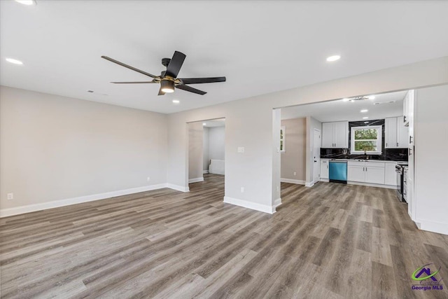 unfurnished living room featuring a ceiling fan, recessed lighting, baseboards, and light wood-type flooring