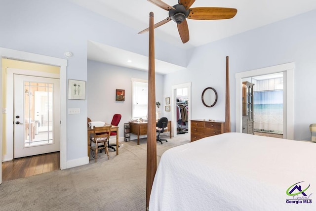 bedroom with a ceiling fan, baseboards, a spacious closet, a closet, and light carpet