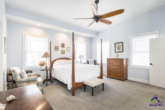 carpeted bedroom featuring a ceiling fan, multiple windows, recessed lighting, and baseboards