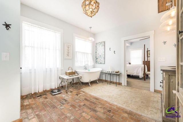 interior space featuring brick floor, visible vents, and baseboards