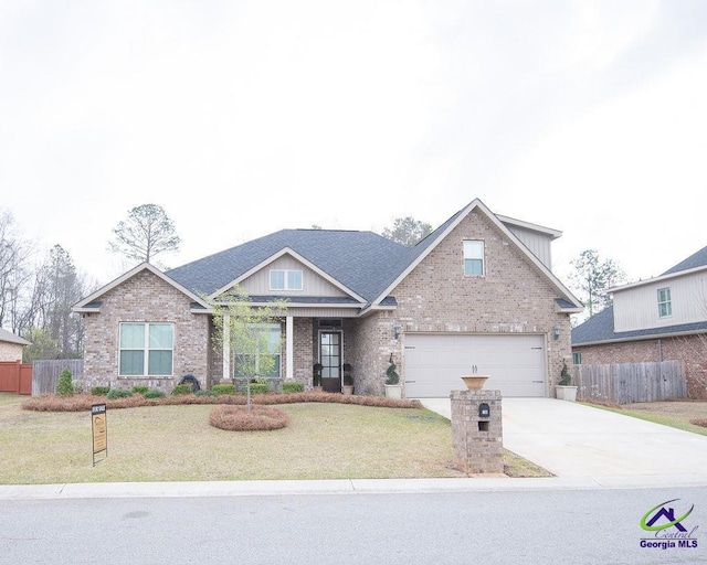 view of front of property featuring brick siding, driveway, a front yard, and fence