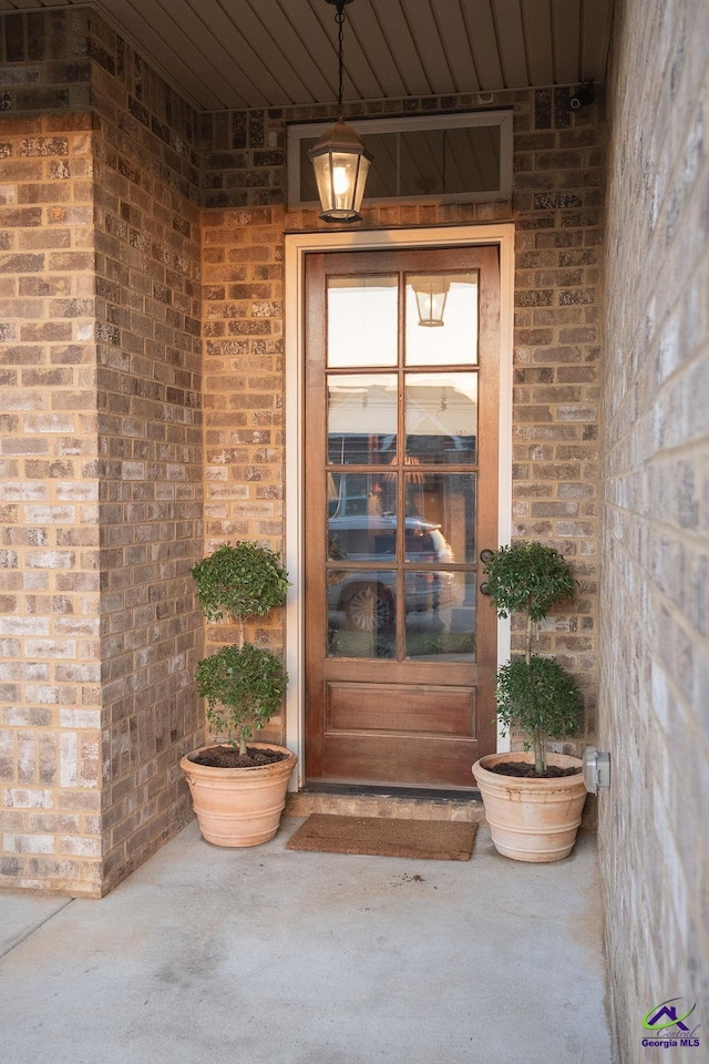 property entrance with brick siding