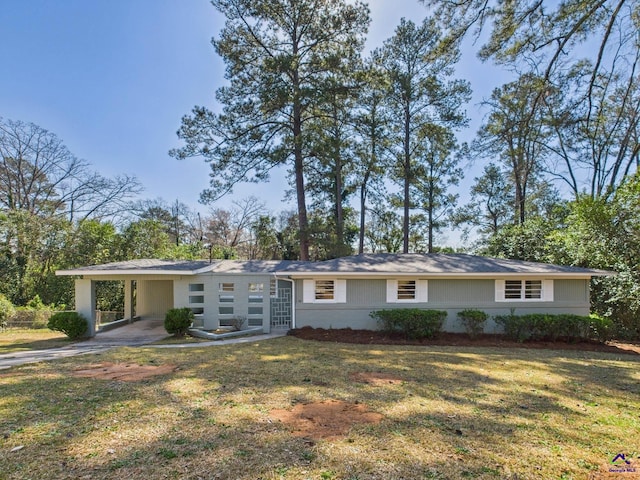 view of front of property with an attached carport, concrete driveway, and a front lawn