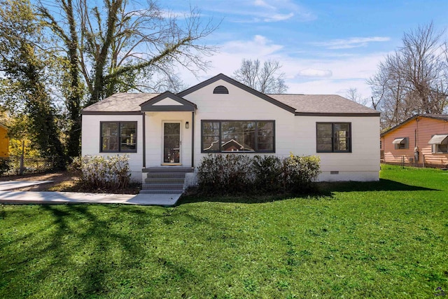 bungalow-style home featuring crawl space, a front lawn, and roof with shingles