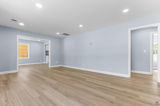 empty room with light wood-style flooring, recessed lighting, and visible vents