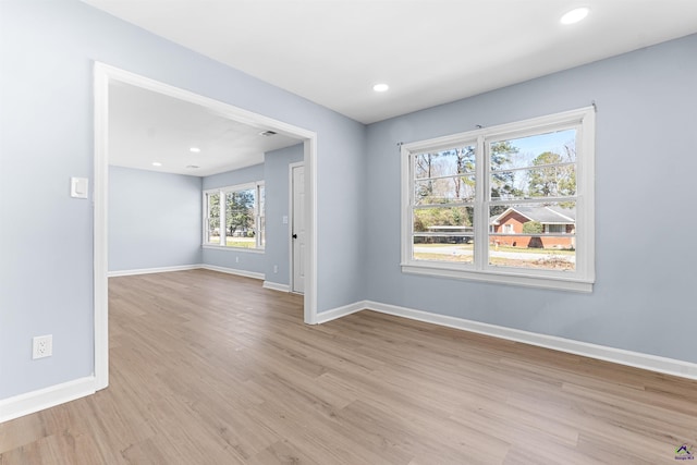 unfurnished room featuring recessed lighting, baseboards, and light wood-style floors