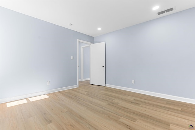 unfurnished room with recessed lighting, visible vents, light wood-style flooring, and baseboards