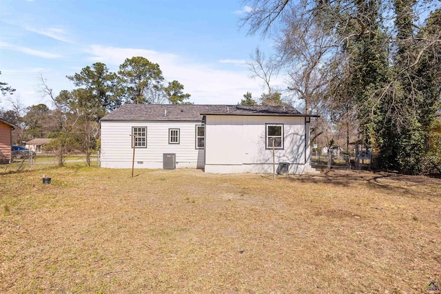 rear view of house with a yard, crawl space, central AC, and fence