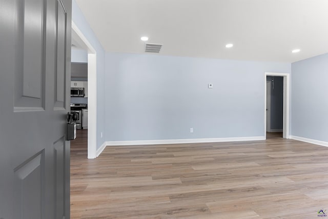 spare room with recessed lighting, light wood-style floors, visible vents, and baseboards