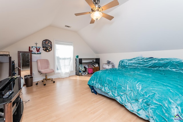 bedroom featuring visible vents, ceiling fan, baseboards, light wood-type flooring, and lofted ceiling