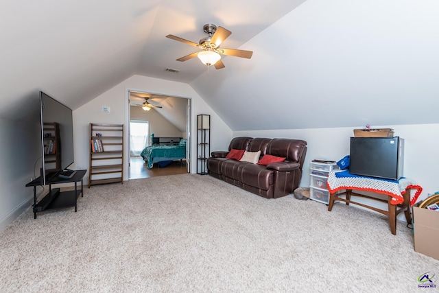 interior space with lofted ceiling, carpet flooring, a ceiling fan, and visible vents