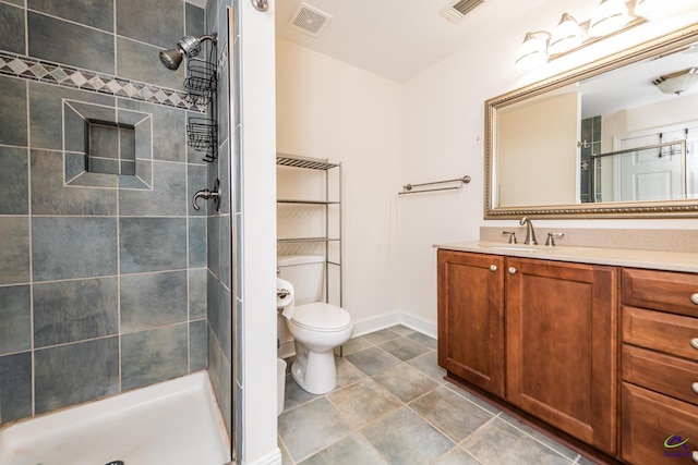 full bath featuring vanity, toilet, visible vents, and a stall shower