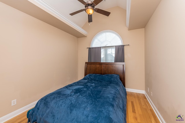 bedroom featuring vaulted ceiling, light wood-style flooring, and baseboards