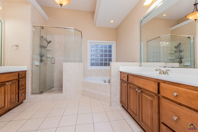 bathroom featuring tile patterned floors, a stall shower, vanity, and a garden tub