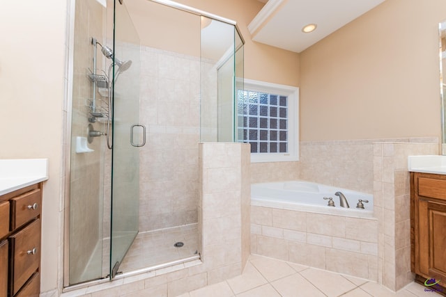 full bath featuring tile patterned floors, a garden tub, a shower stall, and vanity