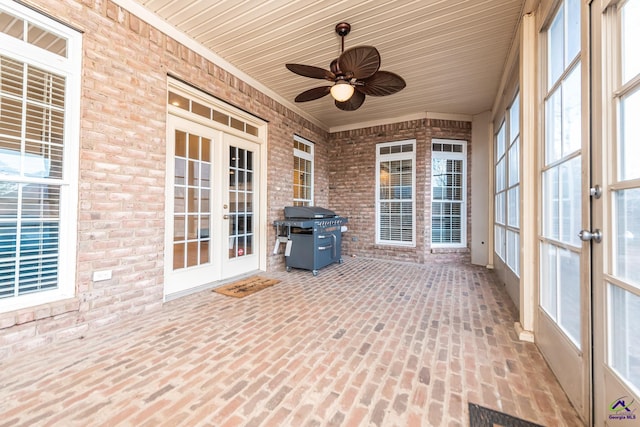 unfurnished sunroom with french doors and a ceiling fan