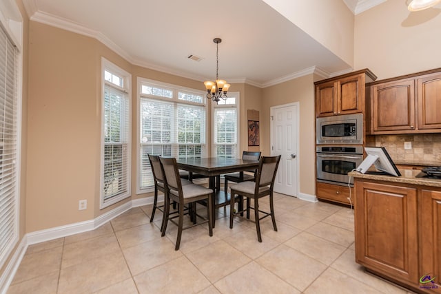 dining area with light tile patterned floors, visible vents, a chandelier, and ornamental molding