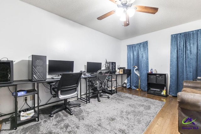 office featuring wood finished floors, a textured ceiling, and ceiling fan