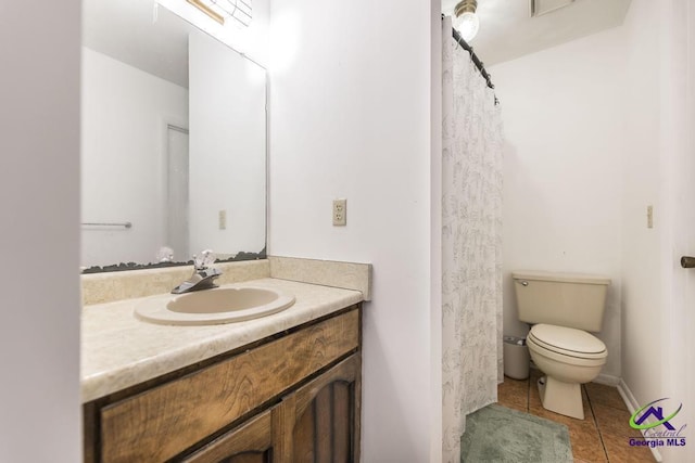 full bath with tile patterned floors, toilet, and vanity