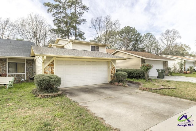 view of front facade with a front lawn, stone siding, concrete driveway, an attached garage, and a shingled roof