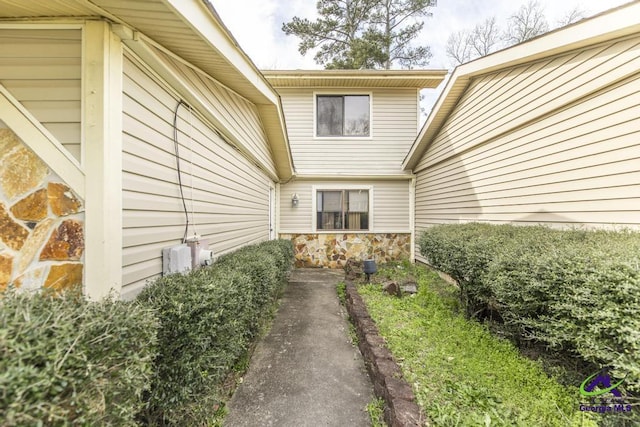 doorway to property featuring stone siding