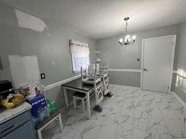 dining area with a notable chandelier, baseboards, and marble finish floor