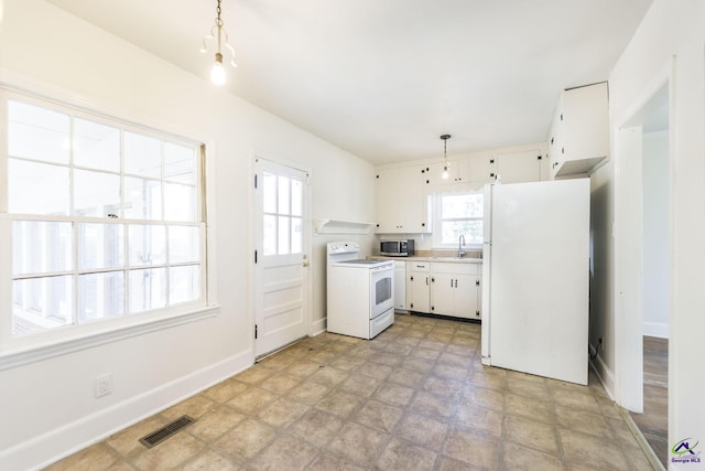 kitchen featuring visible vents, a sink, white appliances, white cabinets, and light countertops