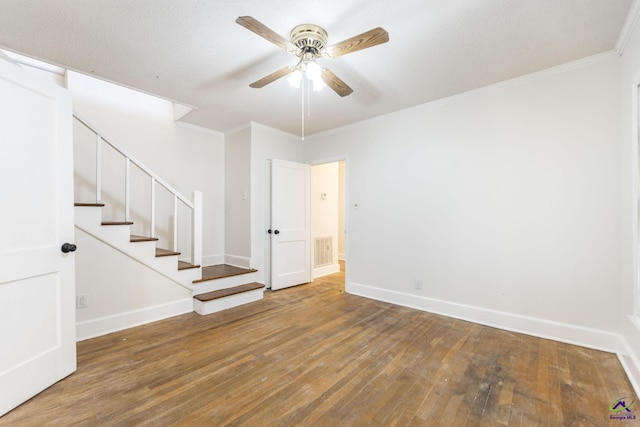 spare room featuring hardwood / wood-style flooring, ornamental molding, and ceiling fan