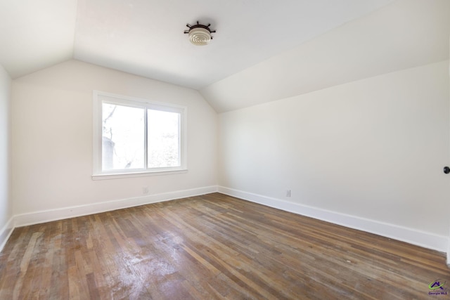 additional living space with vaulted ceiling, baseboards, and wood finished floors